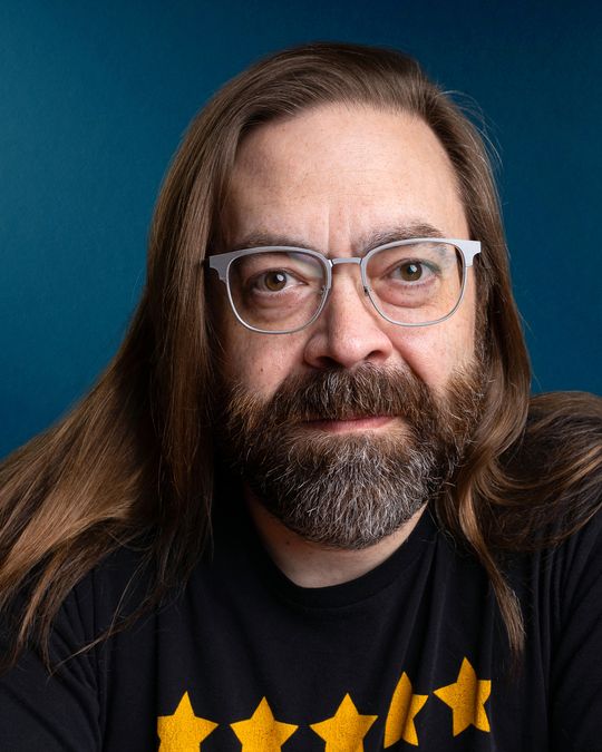 Gabriel Rutledge, close portrait against a deep blue backdrop
