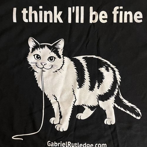Cat Shirt — black t-shirt with a cartoon cat and the text “I think I’ll be fine”